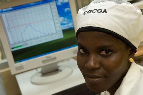 A woman sits in front of a computer screen