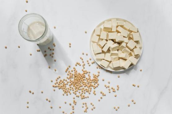 Chopped tofu in a bowl, with soy beans